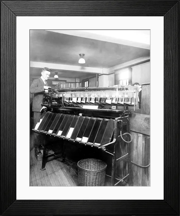 Framed Print : A US Census worker oversees the automatic card sorting machine used for recording census information in 1915 Framed Print : A US Census worker oversees the automatic card sorting machine used for recording census information in 1915