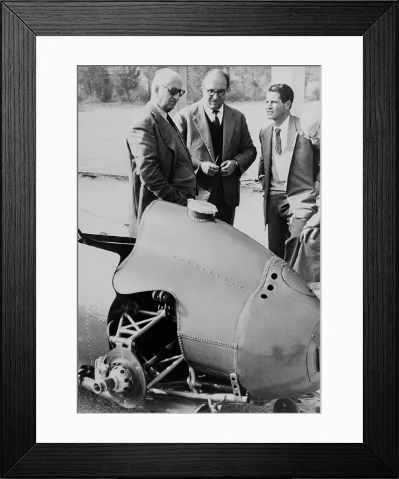 Framed Print : Enzo Ferrari (left), founder and owner of the Ferrari Auto factories Modena, Italy, looks over a 1959 racing car with technicians