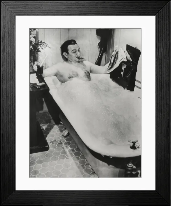 Framed Print : Actor Edward G. Robinson, in a bubble bath with his cigar, drink, and a newspaper. It is a movie still for a 1948 film. - (BSLOC_2014_17_90)