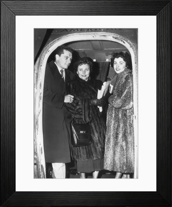 Framed Print : Elizabeth Taylor (right) and her fiance, Nicky Hilton Jr. arrive in Chicago with her mother. March 2, 1950. - (BSLOC_2014_17_98)