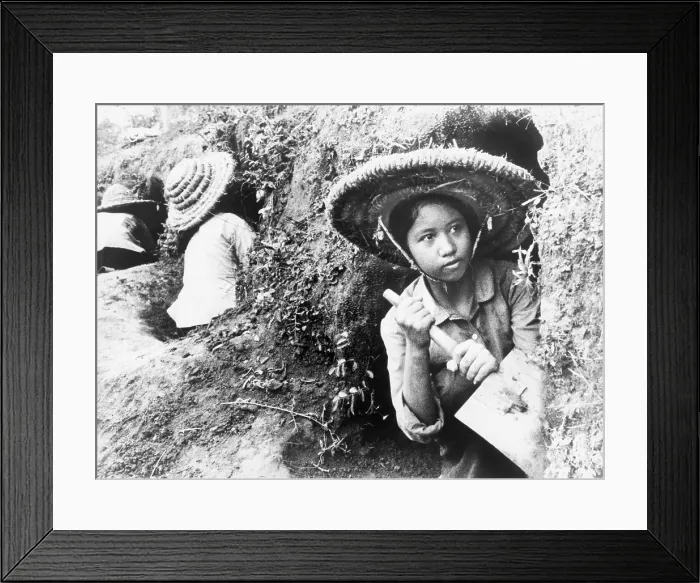 Framed Print : High school girls digging air raid shelters in a hillside in Hanoi, North Vietnam during the American bombings of 1965-1966