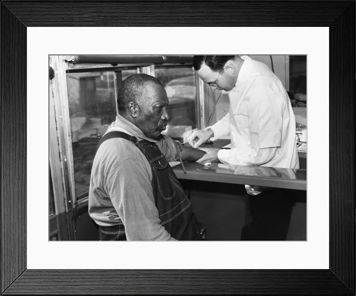 Framed Print : African American patient receiving treatment for syphilis in public health service clinic-on-wheels, Wadesboro, N.C. in the 1930s Framed Print : African American patient receiving treatment for syphilis in public health service clinic-on-wheels, Wadesboro, N.C. in the 1930s