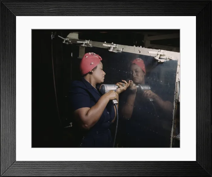 Framed Print : An African American Rosie the Riveter, operating a hand drill at Vultee-Nashville, while working on a Vengeance dive omber, at Vultee-Nashville, Tennessee defense plant