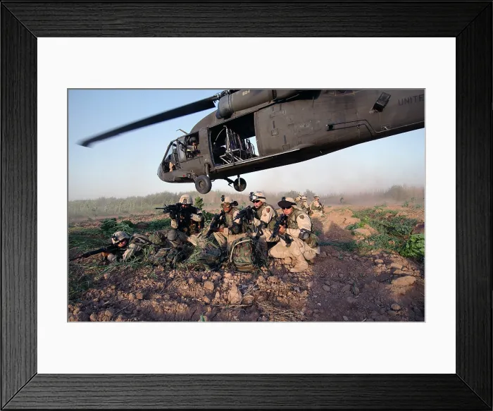 Framed Print : A Quick Response Force brace themselves in a security posture after being dropped off by a Black Hawk helicopter on a mission in Iraq. June 19 2004. (BSLOC_2011_12_152)