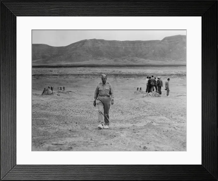 Framed Print : General Leslie Groves (1896-1970), walking across the site of the first atomic bomb blast site at Alamogordo, N.M. in July 1945