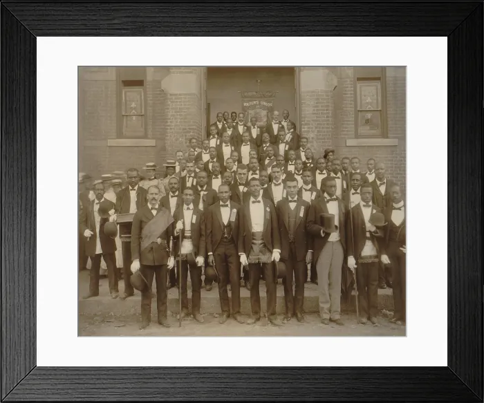 Framed Print : Formally dressed African American men pose with derbies and top hats, and banner labeled Waiters Union in Georgia, ca. 1899