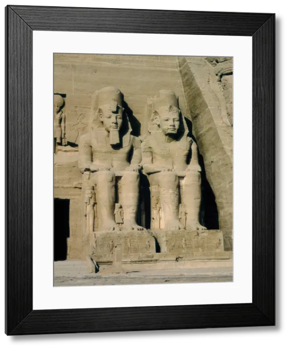 Framed Print : Great Temple of Rameses II. EGYPT. ASWAN. Abu Simbel. Great Temple of Rameses II. Two of the four colossus at the entrance of the temple. Egyptian art. New Kingdom