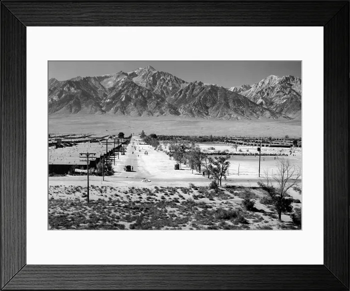 Framed Print : World War II, Bird's-eye view of Manzanar Relocation Center, showing buildings, roads, and Sierra Nevada mountains in background. California. photograph by Ansel Adams. 1943