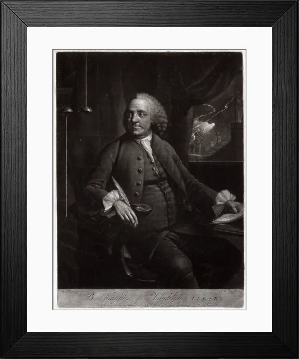 Framed Print : Ben Franklin, seated at desk, next to an electrical device, visible through a window to his left is lightning striking a building. mezzotint ca. 1763-1785