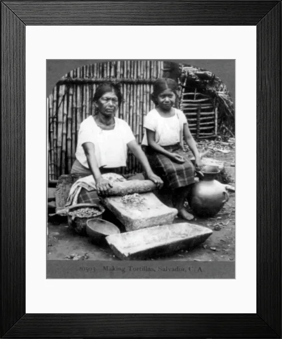 Framed Print : Grinding corn for tortillas with a metate in the streets of Guadalupe, Mexico. 1902