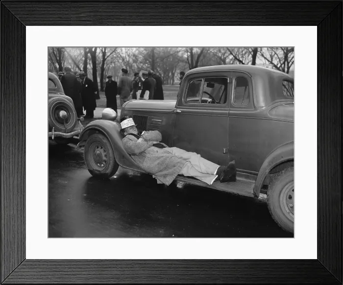 Framed Print : Seamen protest against the Copeland Safety-At-Sea Act. Jan. 18, 1937. One striker takes a nap on an auto running board as his mates protest. (BSLOC_2013_6_116)