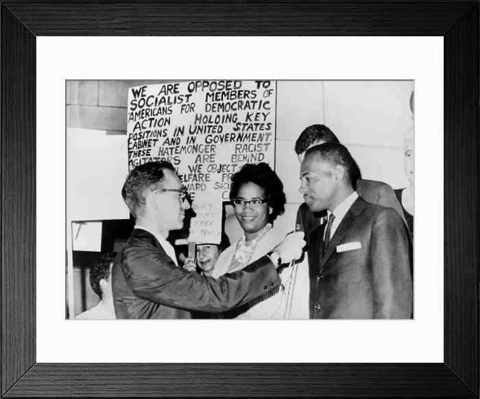 Framed Print : James Meredith and wife in front of segregationist poster as they talk to a reporter. The Fifth U.S