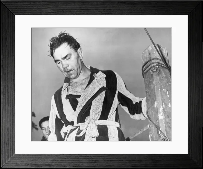 Framed Print : Max Schmeling, 43-year-old former world's heavyweight champion, leaves the ring after losing a fight to Dick Vogt in Berlin, Germany. Shortly afterward, Schmeling retired