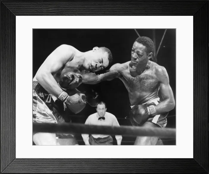 Framed Print : Joe Louis (left), takes a hard right punch in the midsection from Ezzard Charles, in a heavyweight title bout, at New York's Yankee Stadium. Charles won the fight on points Framed Print : Joe Louis (left), takes a hard right punch in the midsection from Ezzard Charles, in a heavyweight title bout, at New York's Yankee Stadium. Charles won the fight on points