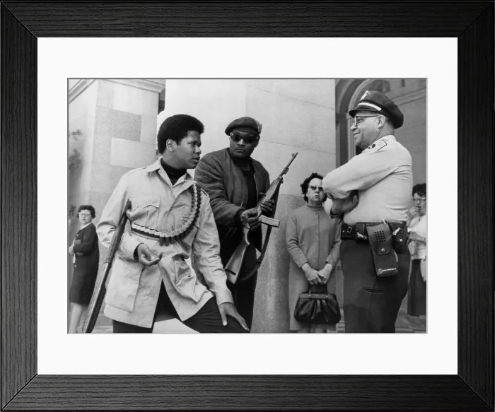 Framed Print : Two armed Black Panthers, carrying a shotgun, and a semi-automatic rifle, talking to officer Lt. Ernest Holloway at the State Capitol, Sacramento, California Framed Print : Two armed Black Panthers, carrying a shotgun, and a semi-automatic rifle, talking to officer Lt. Ernest Holloway at the State Capitol, Sacramento, California