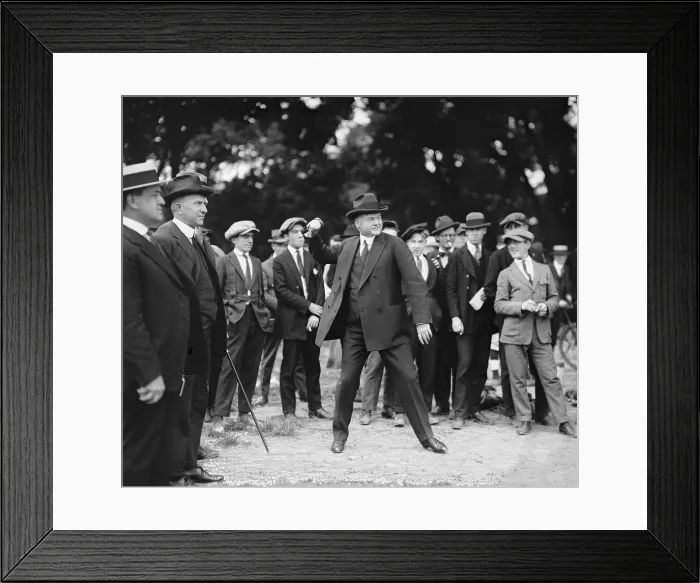 Framed Print : Secretary of Commerce, Herbert Hoover (1874-1964), throws a baseball while a small crowd watches, 1922