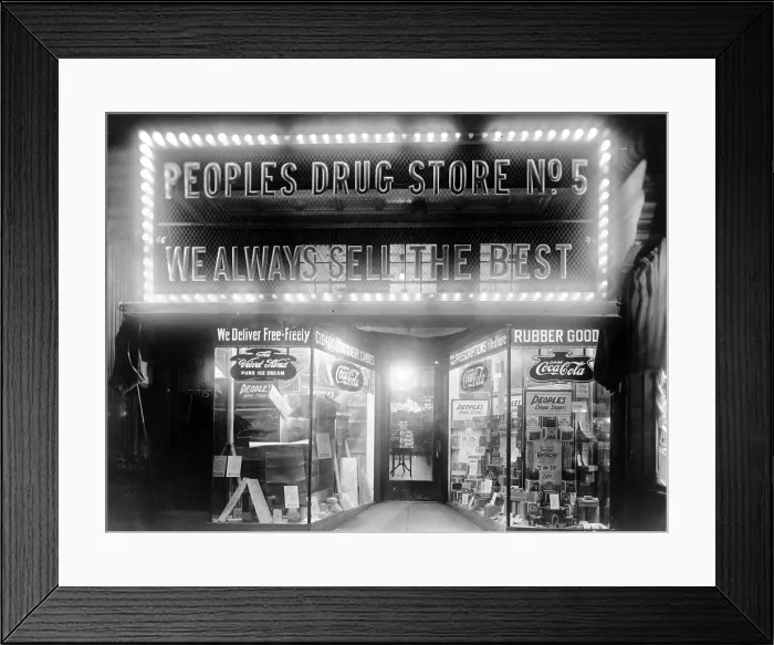 Framed Print : Electric lights and brand names advertise the People's Drug Store at 8th & H Streets, N.E. Washington, D.C. in 1920