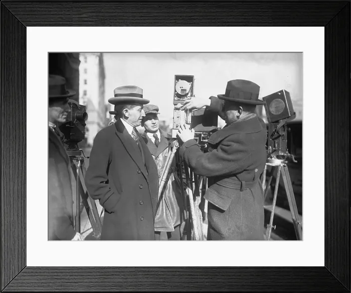 Framed Print : Will Hays (1879-1954), as Postmaster General, examines a newsman's movie camera. Jan. 14, 1922 Framed Print : Will Hays (1879-1954), as Postmaster General, examines a newsman's movie camera. Jan. 14, 1922