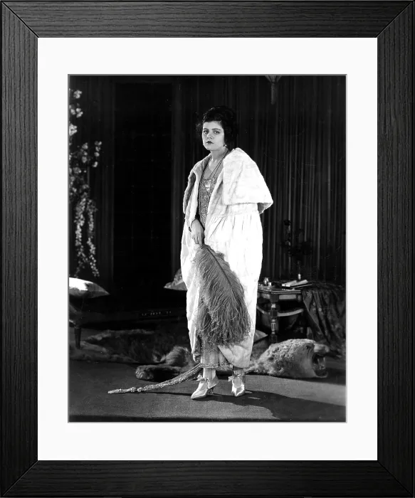 Framed Print : THE SHADOW OF ROSALIE BYRNES, Elaine Hammerstein, wearing a white ermine coat, accented with a blue ostrich plume, 1921