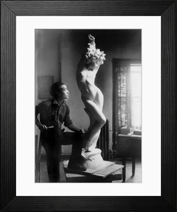 Framed Print : Isamu Noguchi (1904-1988) standing by his sculpture of a nude woman in 1927, an early work he adopted his expressive abstract style. Ca. 1927