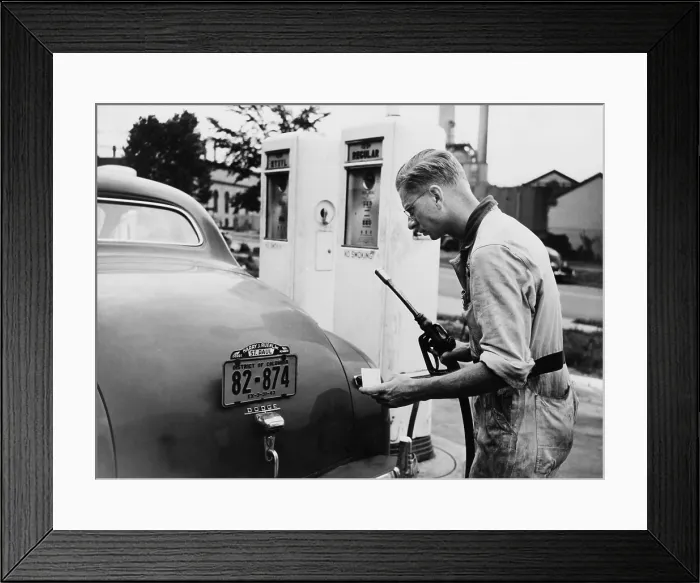 Framed Print : An automobile service station attendant measures out gasoline in accordance with the World War II gasoline rationing. July 1942