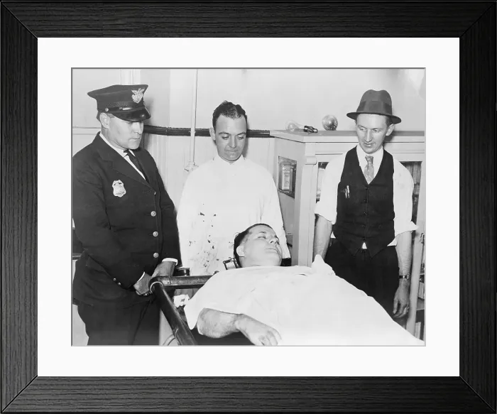 Framed Print : Dead body of Charles Pretty Boy Floyd (1904-1934) on a gurney with police officers Robert Pyle and George Curran, and undertaker Frank Dawson standing nearby
