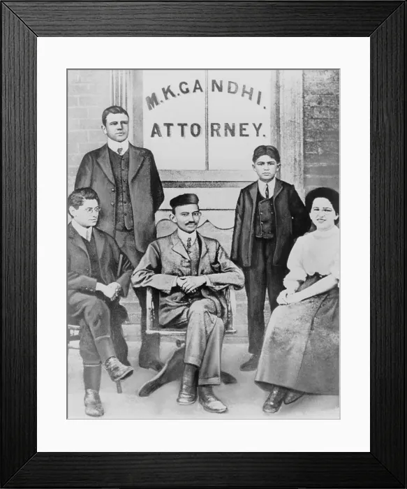 Framed Print : Mahatma Gandhi seated, surrounded by four associates and law clerks in South Africa. Arriving in 1893, he planned to stay only one year