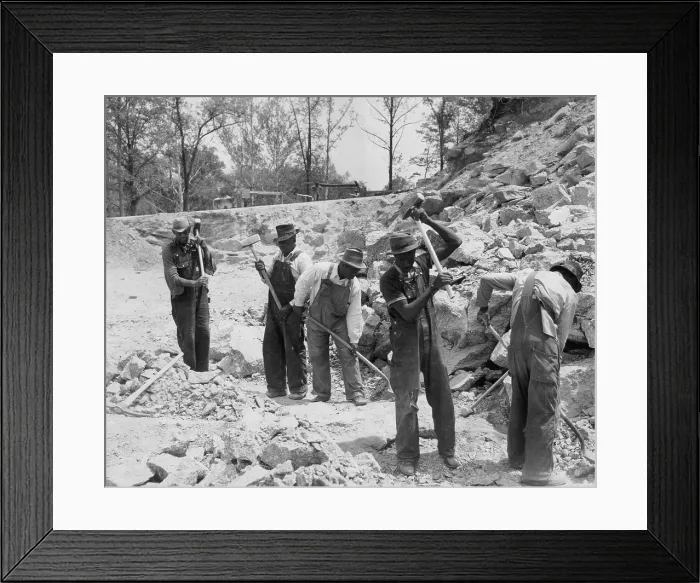 Framed Print : African American convicts in a Southern work gang breaking up rocks with sledge hammers. Ca. 1940