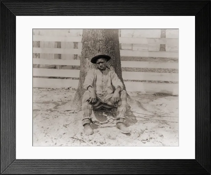 Framed Print : Young African American sitting with legs chained, Thomasville, Georgia. 1890