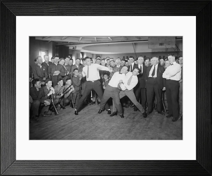 Framed Print : Harry Houdini cannot escape the hold of boxer Benny Leonard and Jack Dempsey prepare to swing. Houdini claimed he could withstand any blow to his stomach Framed Print : Harry Houdini cannot escape the hold of boxer Benny Leonard and Jack Dempsey prepare to swing. Houdini claimed he could withstand any blow to his stomach