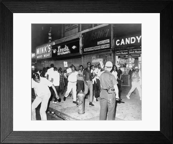 Framed Print : Youthful crowd chanting along the sidewalk on 125th St. during the first inner-city riots of the 1960s in Harlem, New York City. July 15-16, 1964