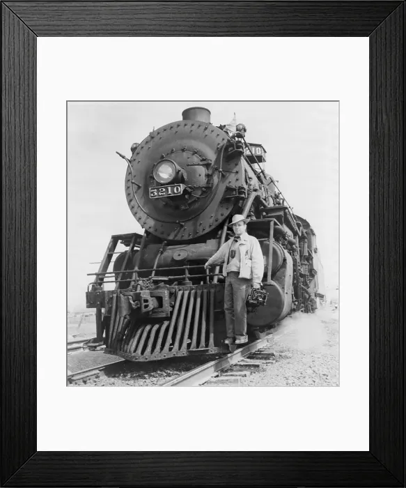 Framed Print : Jack Delano (1914-1997), American photographer with the Farm Security Administration, holding camera, standing on front of locomotive. 1943 Framed Print : Jack Delano (1914-1997), American photographer with the Farm Security Administration, holding camera, standing on front of locomotive. 1943