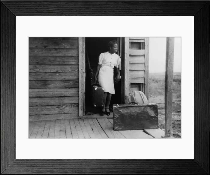 Framed Print : African American women in a doorway with her luggage. The Florida migrant worker will travel from North Carolina to another job in Virginia. July 1940 Framed Print : African American women in a doorway with her luggage. The Florida migrant worker will travel from North Carolina to another job in Virginia. July 1940