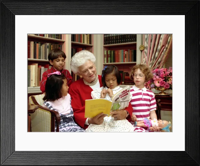 Framed Print : First Lady Barbara Bush reads to children in the White House Library. As First Lady, she supported literacy programs and encouraged family reading. July 24, 1990