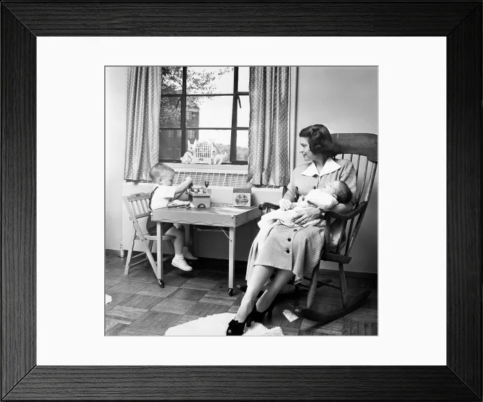 Framed Print : Future First Lady in 1952. Betty Ford holds her second son, Jack, while her eldest son Michael plays at a small table in their apartment