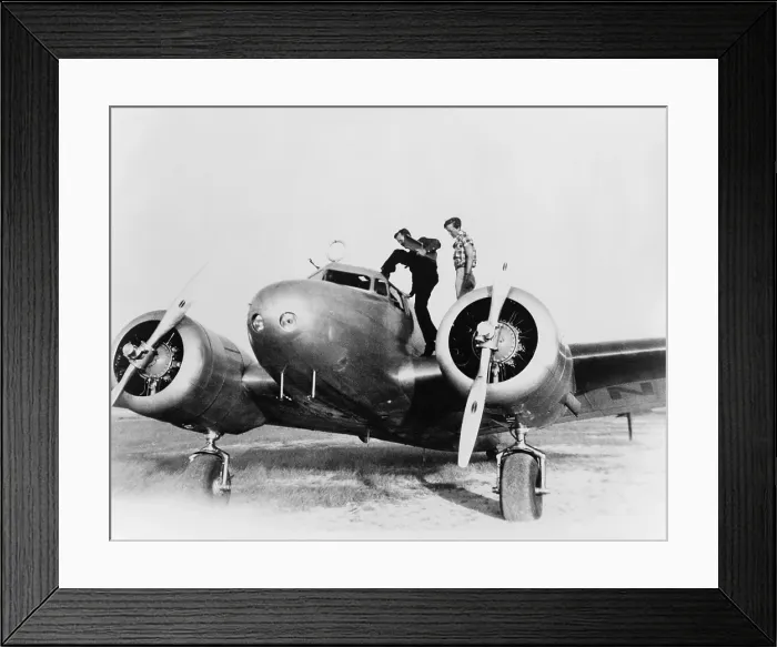 Framed Print : Amelia Earhart stanind on the wing of her Lockheed L-10E Electra airplane