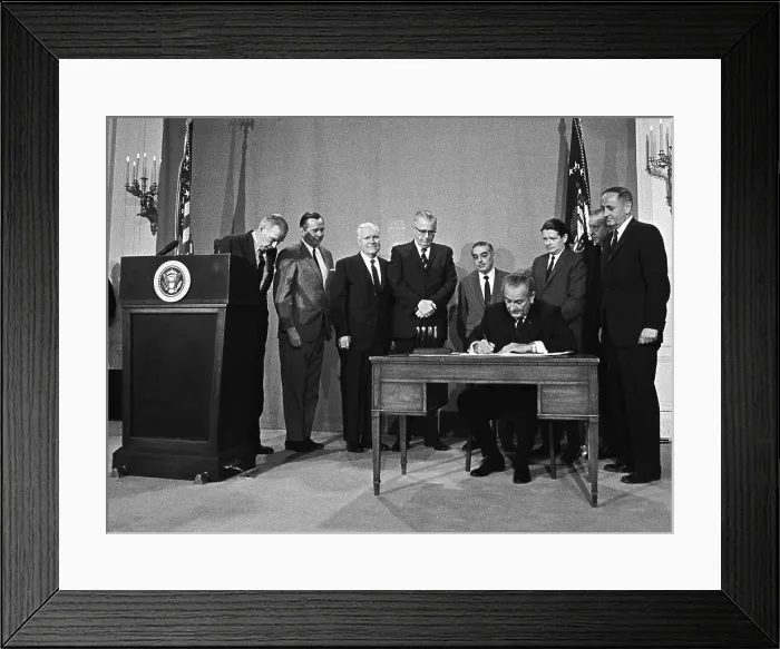 Framed Print : LBJ's Great Society programs. President Lyndon Johnson signing of Public Broadcasting Act of 1967. HEW Sec. John Gardner is standing behind him at right. Nov. 7, 1967