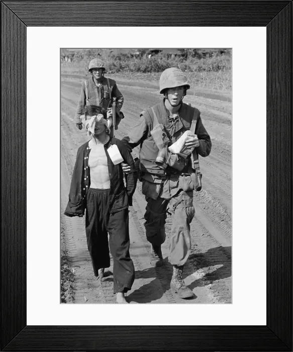 Framed Print : Vietnam War. A Viet Cong prisoner captured during Operation Double Eagle, 20 miles south of Quang Ngai, Vietnam is brought into the collection area by Marines