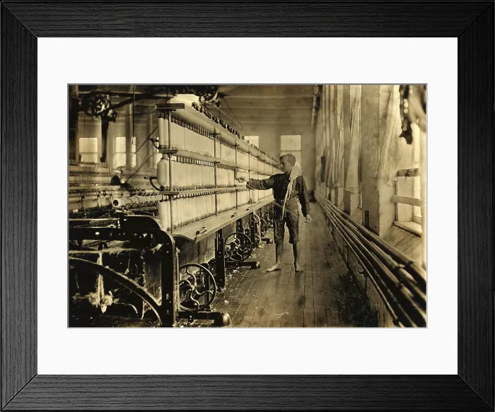 Framed Print : Young Raoul Julien had already worked for two years in the mule-spinning room in Chace Cotton Mill, Burlington, Vermont, when Lewis Hine took this photo in 1909