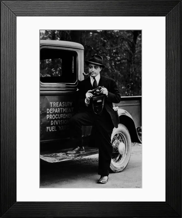 Framed Print : Carl Mydans (1907-2004), Farm Security Administration photographer, holding camera, standing on the running board of a Treasury truck, Washington, D.C. Self-portrait of 1935