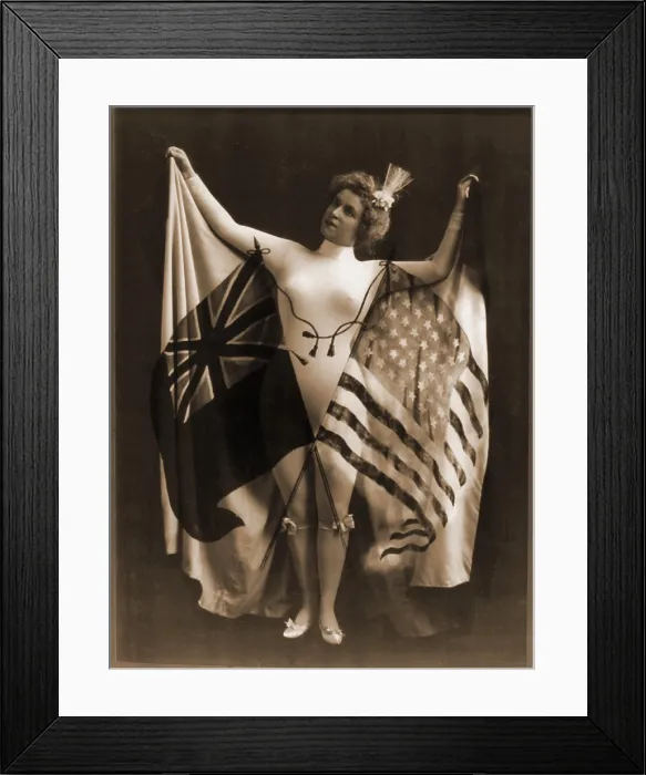 Framed Print : Female vaudeville performer in white body suit, wearing a cape of U.S. and British flags
