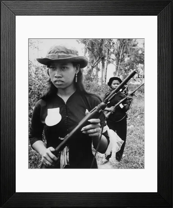 Framed Print : Vietnam War. Girl volunteers with fine manicures and jewelry, are part of the People's Self-Defense Force of Kien Dien