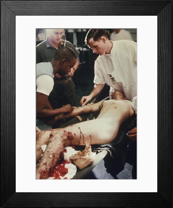 Framed Print : Vietnam War. US Marine Corporal is given treatment in the shock and resuscitation ward of the amphibious assault ship USS Tripoli Framed Print : Vietnam War. US Marine Corporal is given treatment in the shock and resuscitation ward of the amphibious assault ship USS Tripoli