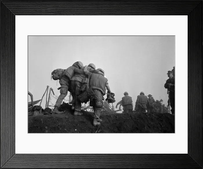 Framed Print : Vietnam War. A US Marine is helped to an evacuation point after he was wounded during Operation Dewey Canyon