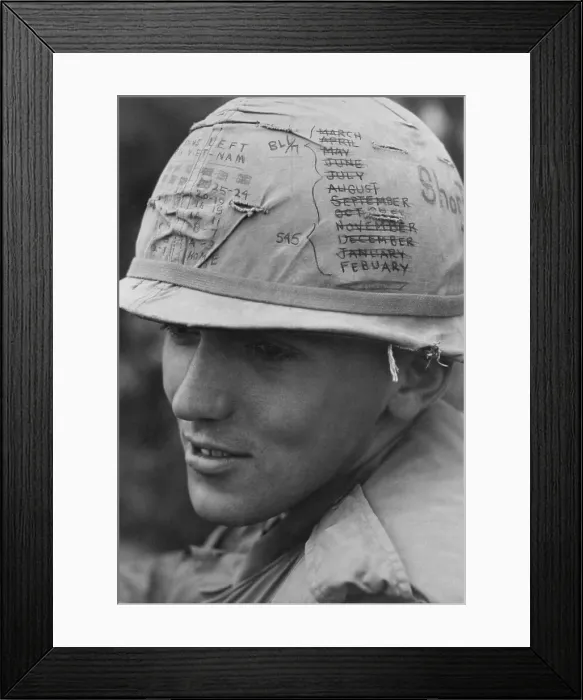 Framed Print : Vietnam War. A US Army sky trooper helmet keeps track of the months time he has left on his thirteen month tour of duty. February 1968 Framed Print : Vietnam War. A US Army sky trooper helmet keeps track of the months time he has left on his thirteen month tour of duty. February 1968