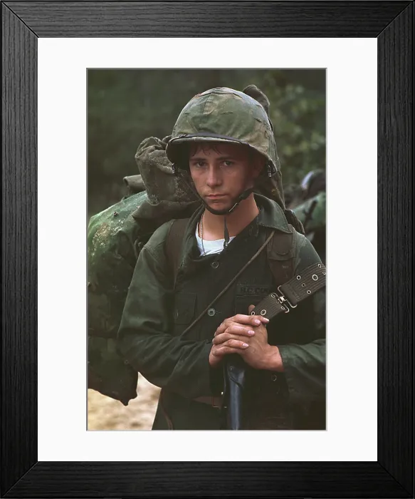 Framed Print : Vietnam War. Da Nang, Vietnam. A young Marine private waits on the beach during the Marine landing on August 3, 1965