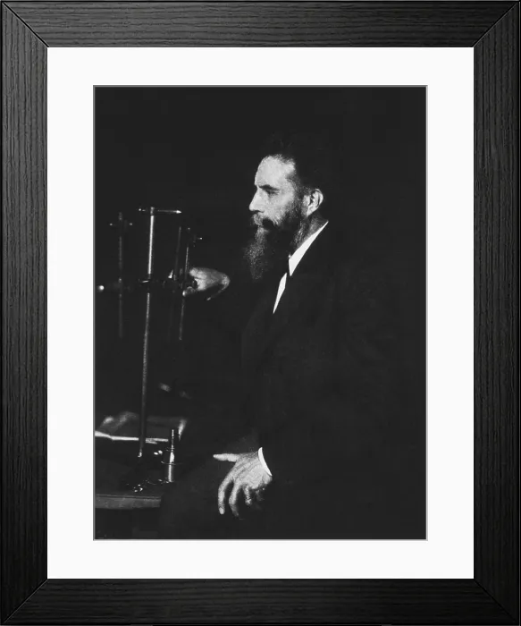 Framed Print : Wilhelm Roentgen (1845-1923), German physicist, discoverer of X-rays, standing beside one of his machines. Photogravure, ca. 1895