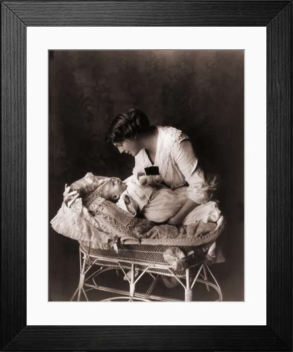 Framed Print : Ethel Barrymore (1879-1959), leaning over the crib of her third child, John Drew Colt (1913-1975) in 1913