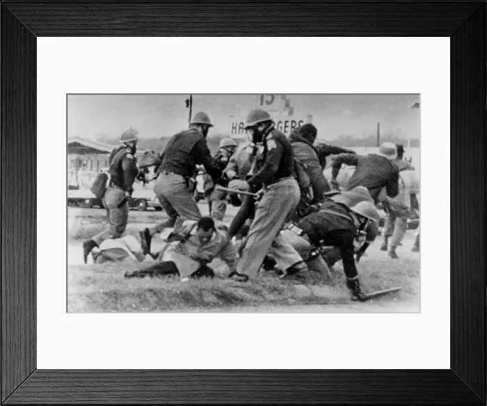 Framed Print : SNCC leader John Lewis (light coat in center) cringes as an Alabama State Trooper swings his club at Lewis head. Lewis was hospitalized for a head injury. March 7, 1965