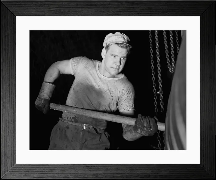 Framed Print : Defense worker at the Goodrich rubber plant molding rubber with a wooden paddle. December 1941 Framed Print : Defense worker at the Goodrich rubber plant molding rubber with a wooden paddle. December 1941